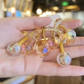 Detail of amber cherry crystal beads on a yellow elastic hair tie with faceted finish - Yellow