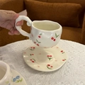 Detail of irregular white ceramic coffee cup with hand-painted cherries and lace tablecloth - Girly Style Cherry Cup & Saucer Set / Cup + Saucer Set