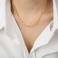 Elegant gold titanium steel link chain necklace shown on model with a white shirt - Cube Style / Gold