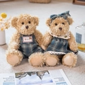 Charming teddy bear couple in blue plaid outfits on a cozy soft carpet setting - Green Plaid Skirt Pair