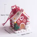 Detail of a lighted clay gingerbread house ornament with dimensions 7.8cm height and 5.5cm width - Christmas House 17 (Snowman & Candy)