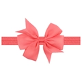 Close-up of coral pink grosgrain ribbon bow headband showing fine fabric texture - Watermelon red