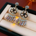 Detail view of Bohemian tassel earrings with blue beads and crystals on a velvet box - Multicolor (Steel Needle)
