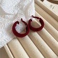 Close-up of wine red velvet C-shaped hoop earrings on a beige textured jewelry stand - 13# Silver Earring Post - Red Painted Multi-layer C-Shape Studs