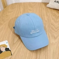Light blue baseball cap with white Hello Weekend embroidery on wooden background - Blue