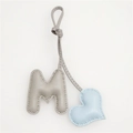 Detailed view of handmade leather M letter bag charm with blue heart and gray pebble texture - Light Blue Heart and Grey M