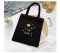 Black canvas tote bag featuring a yellow star and I will Smile text in a lifestyle setup - Star Black