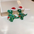 Close-up of glittery green Christmas dinosaur earrings with festive red holiday hats - Green Small Dinosaur (34# Silver Needle) / Green