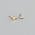 Macro detail of triangle cut zircon stud earrings with minimalist gold claw setting - Triangle Style