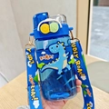 Detail showing the adjustable dinosaur strap and push-button lid of this blue kids water bottle - 520ml / 2058 Blue Dinosaur