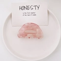 Pink marble texture acetate claw clip shown from above on a minimalist white tray - Pink White