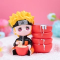 Cute Naruto anime figure sitting and eating ramen on a soft pink decorative background - Eating Noodle Boy Figure (2021-15 Red Naruto)