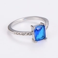 Macro view of square blue gemstone ring with small diamond accents on silver band - US 7 / Steel/Blue Zirconia