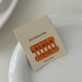 Close-up of three orange bone-shaped hair clips on a handmade accessories card - Orange (Set of 3)