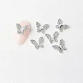 Close-up of a silver butterfly nail charm with mini zircons on a pink manicure - Silver Full Rhinestone Butterfly Style (7179)