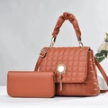 Detail of brown quilted leather bucket bag and matching wallet with metal tassel - Large Bag and Wallet Set / Caramel Brown