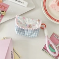 Detail of blue checkered padded pouch with pink pom-pom trim and a convenient wrist strap - Snowflake Bear