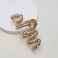 Macro shot of S-shaped wave hair claw featuring brown marble texture on white stand - 13cm Snake Wave / Brown Marble