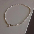 Elegant natural freshwater pearl necklace with gold clasp on a beige leather background - Regular Clasp / White