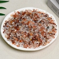 Polished natural citrine and brown crystal gravel stones displayed on a white plate - 100g Of Red Styrax Flowers (5-7mm)