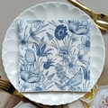 Floral paper napkin with blue bird and flower print on a white shell-shaped plate - Blue Floral & Birds (1119)
