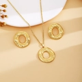 Detail of gold hammered organic jewelry set featuring irregular round necklace and earrings - Gold Hammered Round Style