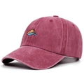 Detailed macro view of vintage washed burgundy cotton baseball cap with embroidered logo - Adjustable / Burgundy