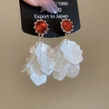 Detailed macro of crystal pearl tassel earrings with red gemstone and white petals - Red Petal (Silver Needle)