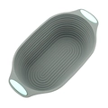 Gray oval silicone cake mold with green handles and non-stick texture on white background - 10.5 Inch Oval Foldable Bread Proofing Basket