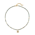 Beaded necklace featuring turquoise stones and a gold-tone sunburst star pendant - African Turquoise Necklace