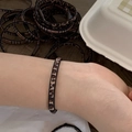 Close-up of leopard print elastic hair tie worn on wrist showing fabric texture - Leopard Single Strand