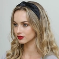 Close-up of a knotted black velvet wide headband worn by a model for a stylish look - Black