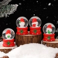 Set of four Christmas snow globes with Santa gnome figures on red holly bases - 203# (lights + Snowflakes) / 45# (cardboard Box Packaging)