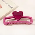 Close-up of a pink heart claw clip showing the glossy plastic texture and sturdy teeth - Heart Hollow Rectangle / Rose Red