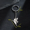 Silver metal fairy pendant keychain with detailed wings on dark textured stone background - 093-Flying Elf