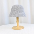Women's minimalist grey plush bucket hat in a thick fleece knit style on a wood stand - Gray