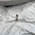 Macro shot of silver stainless steel stud earring with a claw-set pink heart zircon stone - Pink