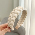 Close-up of beige woven fabric headband showing intricate texture and inner lining details - Beige