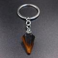 Macro detail of natural tiger eye stone hexagonal pendant on silver keychain - Tiger Eye Stone Bracelet