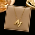 Minimalist gold-plated letter M pendant necklace on premium jewelry display box - Gold-M