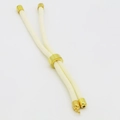 Detail of adjustable cream braided cord with gold cylindrical slider for DIY bracelets - White
