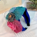 Detail of blue fabric headband featuring colorful handmade flowers and hanging tassels - Blue Gold