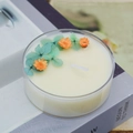 Handmade dried flower aromatherapy candle with orange daisy on vintage book background - Bluebell