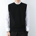 Men's minimalist black knitted vest with round neck layered over a white shirt - Black