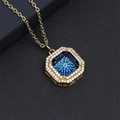 Close-up of golden octagonal necklace with deep blue crystal and white zircon pavé - Blue