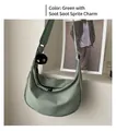 Detail of light green nylon hobo bag with a cute black soot sprite plush pendant - Soot Sprite Charm Style / Green