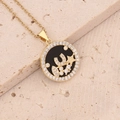 Detail shot of a gold round pendant with black enamel inlay and zircon crescent moon stars - Black Star Moon Disc