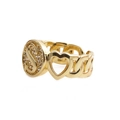 Macro shot of gold initial S ring with cubic zirconia inlay and heart cutout detail - Letter S