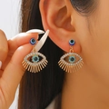 Close-up of bohemian gold evil eye earrings with blue crystals and eyelash details - 08 KC Gold Style (7687)