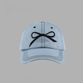 Detailed embroidery of a black bow and stitching on light blue denim baseball cap surface - Denim Bow Baseball Cap Style / Light Blue